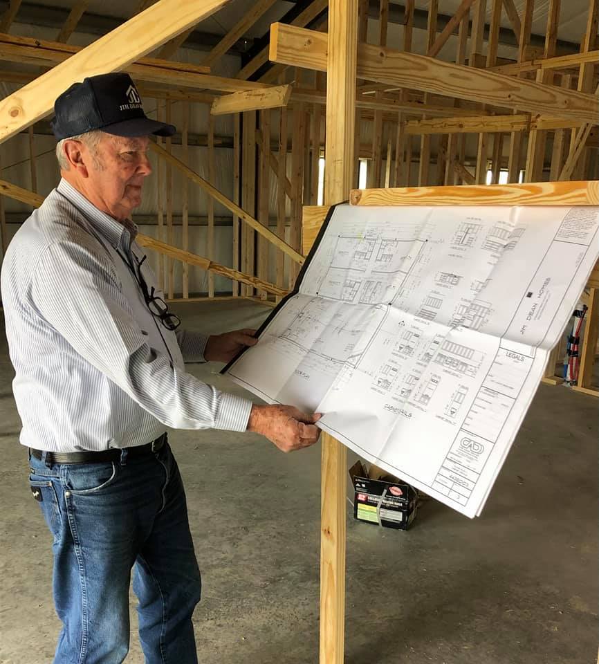 Man examining construction blueprints in a building