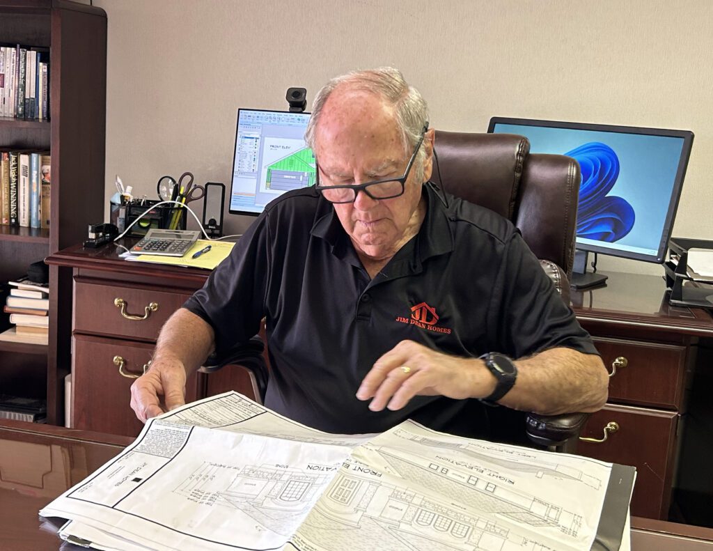 Man reviewing architectural plans at desk